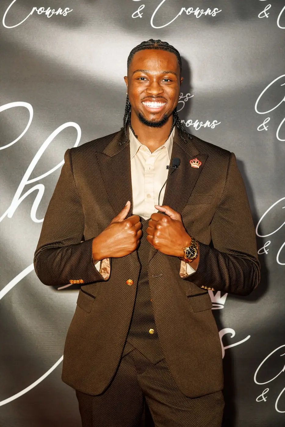 Isaac Jamerson, founder of The Jamerson House, smiling in a brown suit